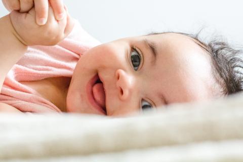 baby smiling at the camera