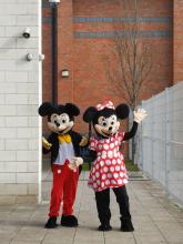 Mickey Mouse and Mini Mouse enroute to the Adoption Fun Day at The Grange School, Levenshulme in Manchester, England