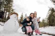 adopter parent with children outdoors in the snow