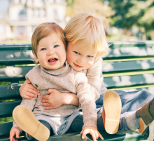 brothers hugging on a bench
