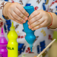 Child using blue paint