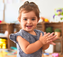 Photo of little girl clapping